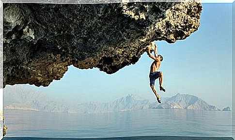 Man hanging on a rock