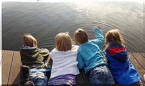 Children lie on their stomach on a scaffold