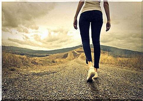 Woman walking a road alone