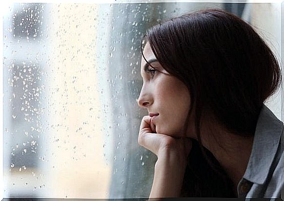 Sad woman staring out the window