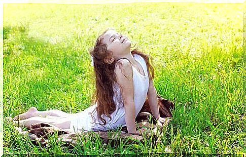 Girl doing yoga in the grass