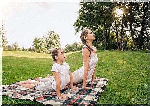 Mother and daughter doing the cobra pose