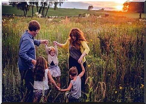 Family dancing in the grass