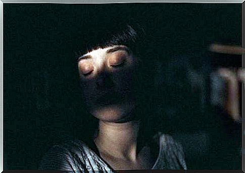 Woman sleeps in the dark