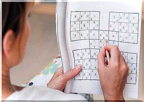 A woman does a Sudoku