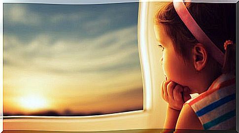 Girl Looking Out Her Window At A Sunset