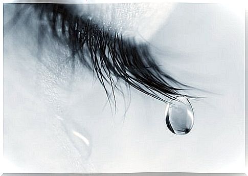 Tear hanging from that eyelash of a woman going through the grieving process