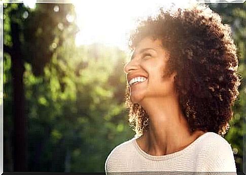 Smiling woman with trees in the background