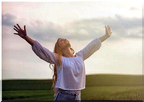 A woman stretches out her arms