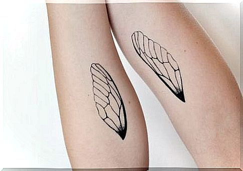 Girl with a tattoo of a wing on each arm because time flies, but so does she