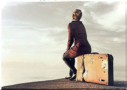 Woman sitting on suitcase