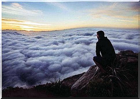 man looking at ocean